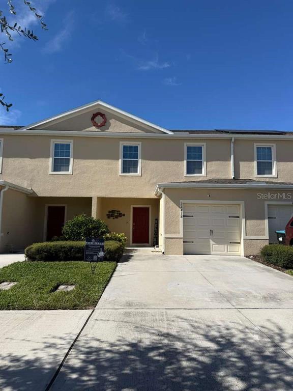 12418 Bowes Branch Road Orlando, FL 32824 - Photo 2 of 21 a front view of a house with a yard