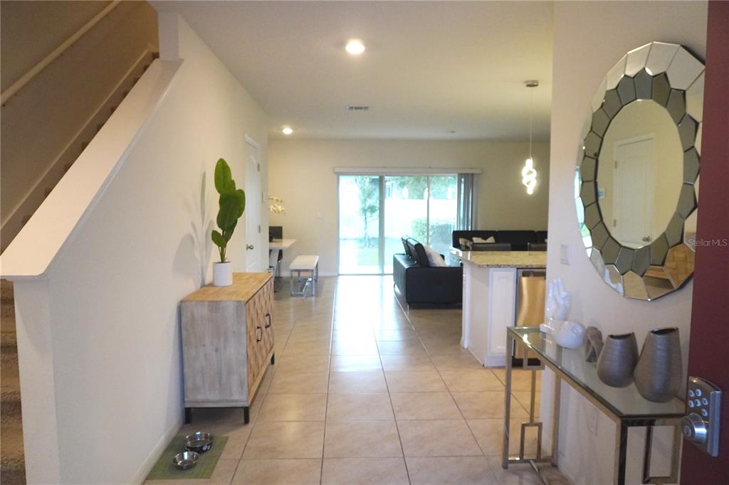 12418 Bowes Branch Road Orlando, FL 32824 - Photo 4 of 21 a lobby with furniture and a mirror