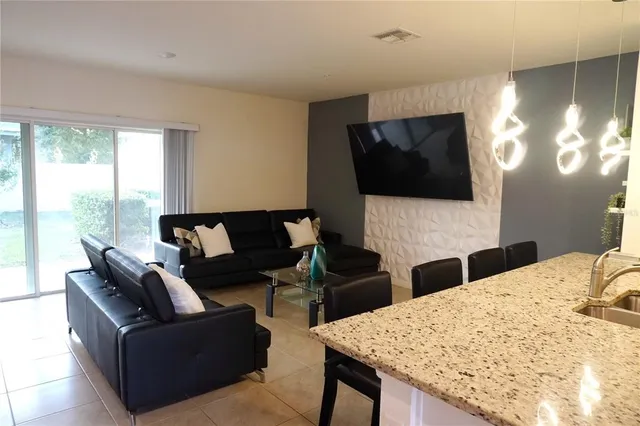a living room with fireplace furniture and a flat screen tv
