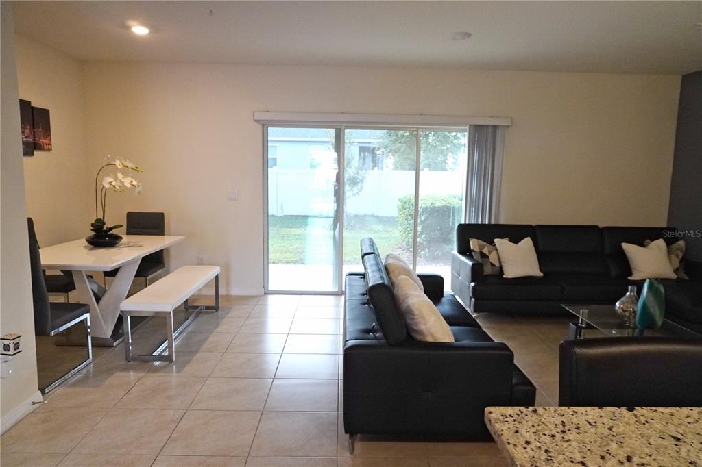 12418 Bowes Branch Road Orlando, FL 32824 - Photo 9 of 21 a living room with furniture and a large window