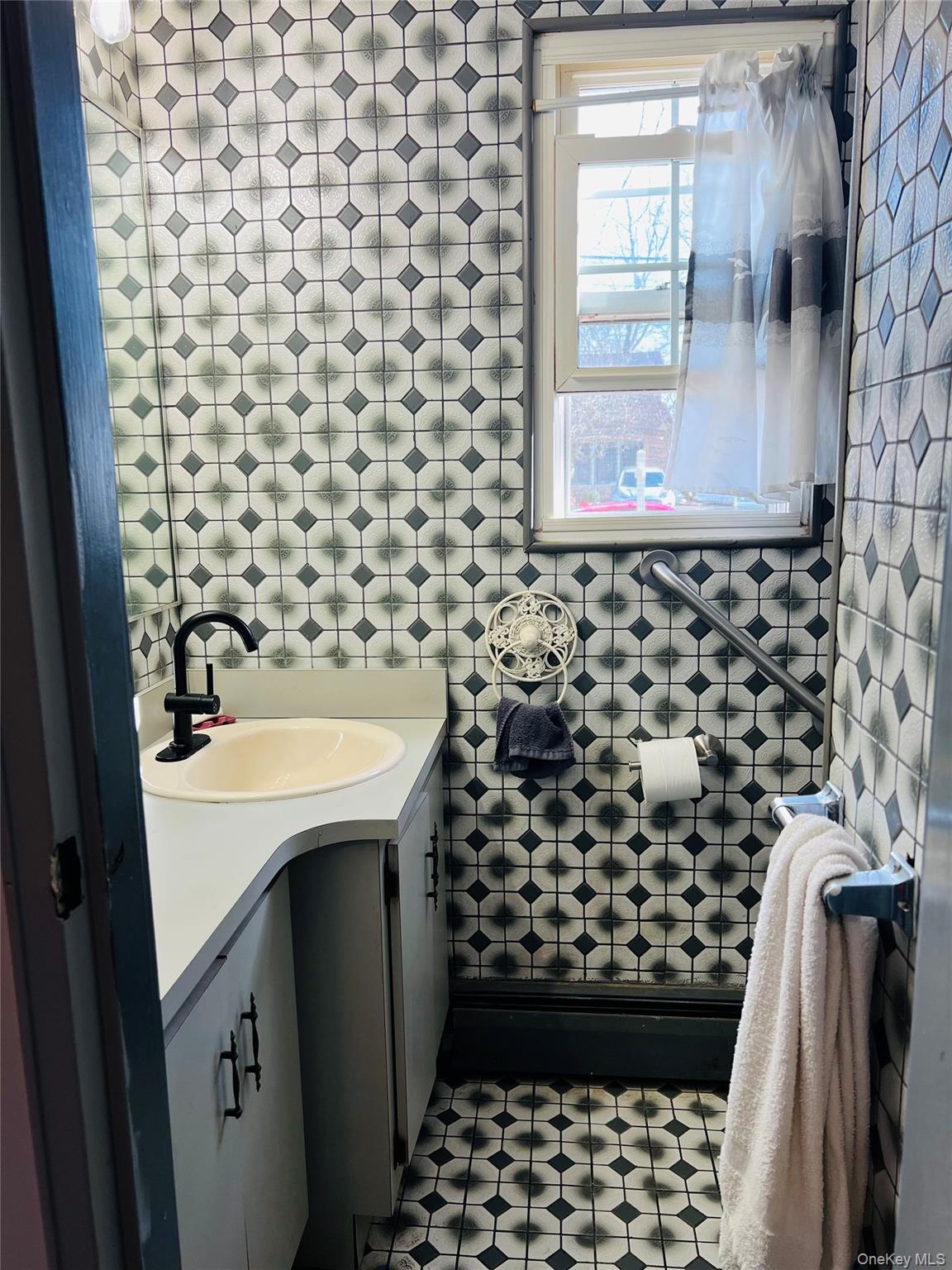 38 Riviera Drive Selden, NY 11784 - Photo 10 of 12 1/2 Bathroom featuring vanity and tile patterned floors