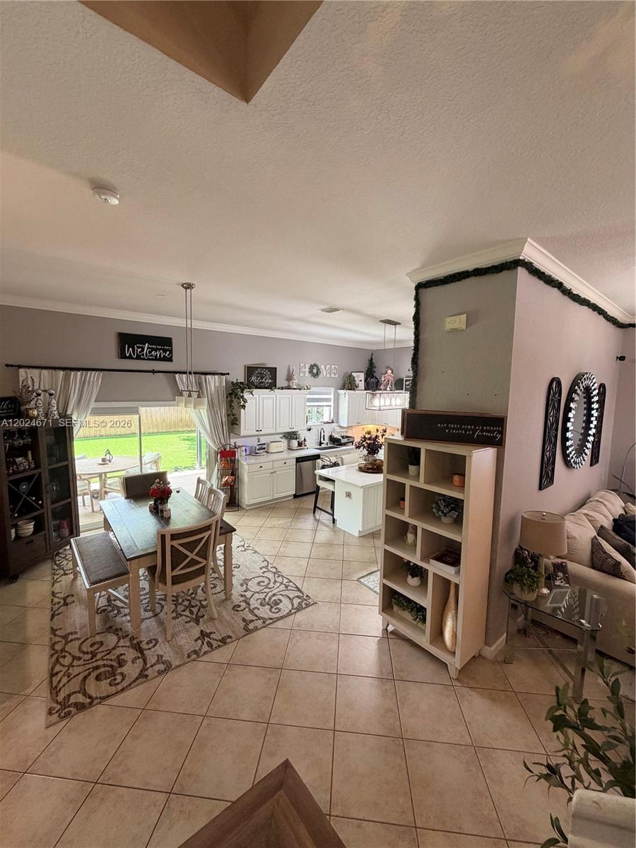 2116 Northeast 38th Road, Unit 2116 Homestead, FL 33033 - Photo 7 of 31 a living room with furniture a rug and white walls