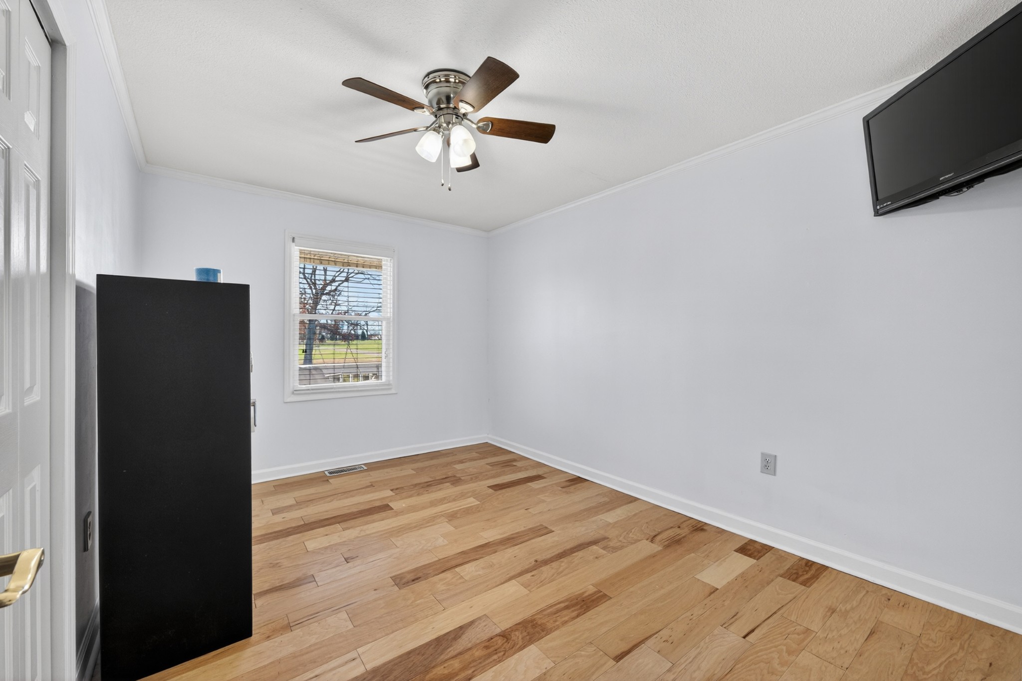 16 Clayton Acres Road Fayetteville, TN 37334 - Photo 17 of 33 an empty room with wooden floor a flat screen tv