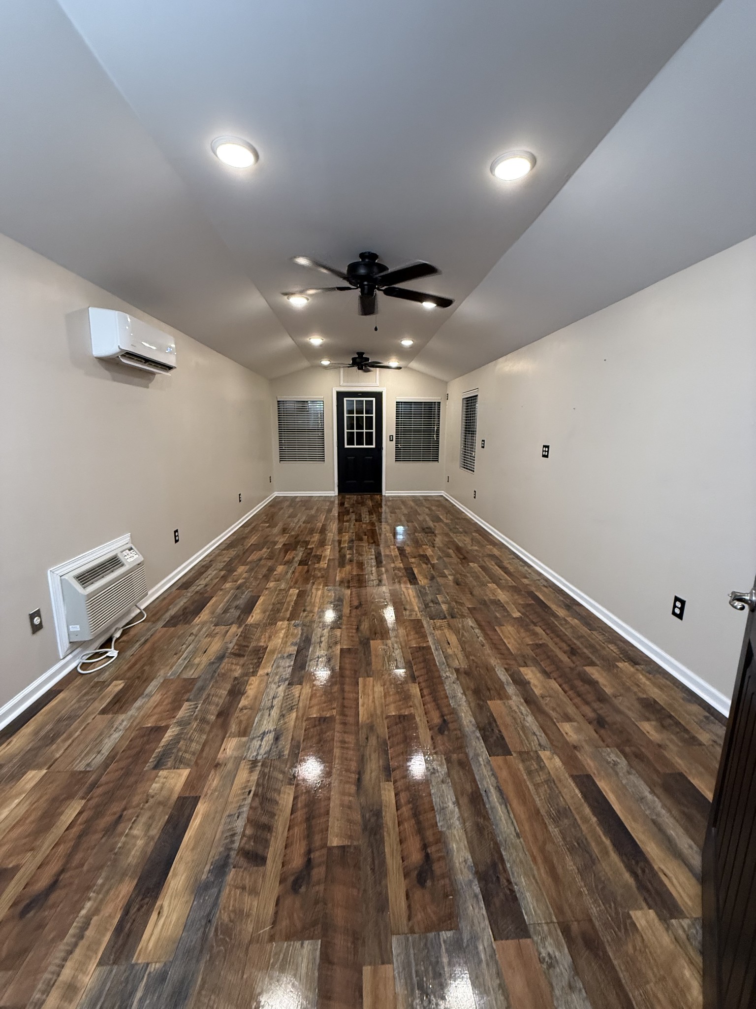 16 Clayton Acres Road Fayetteville, TN 37334 - Photo 23 of 33 an empty room with wooden floor ceiling fan and windows