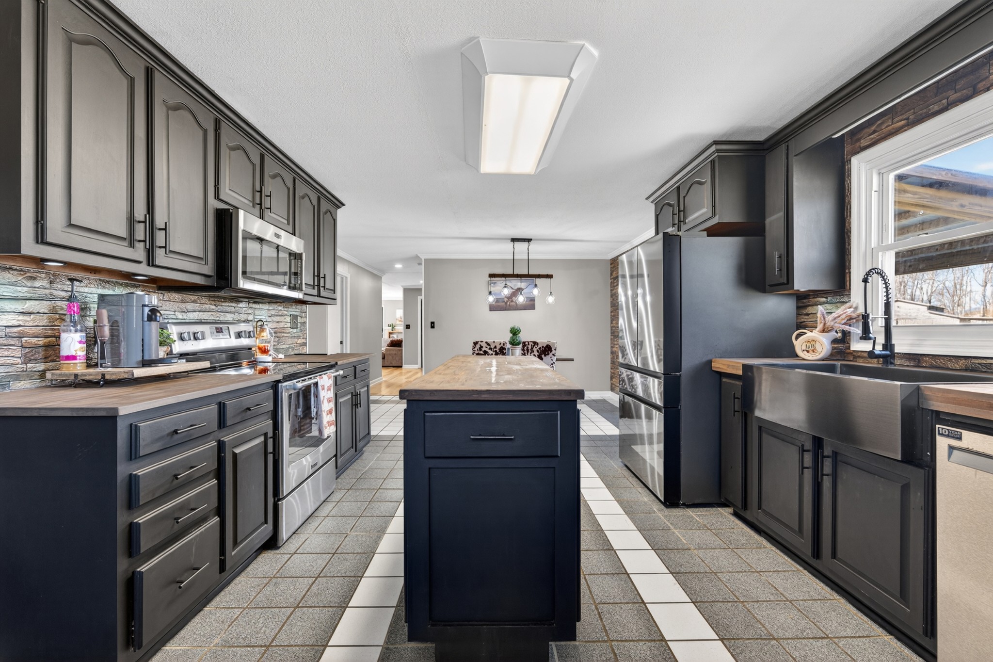 16 Clayton Acres Road Fayetteville, TN 37334 - Photo 6 of 33 a kitchen with stainless steel appliances granite countertop a refrigerator a sink dishwasher a stove with wooden cabinets