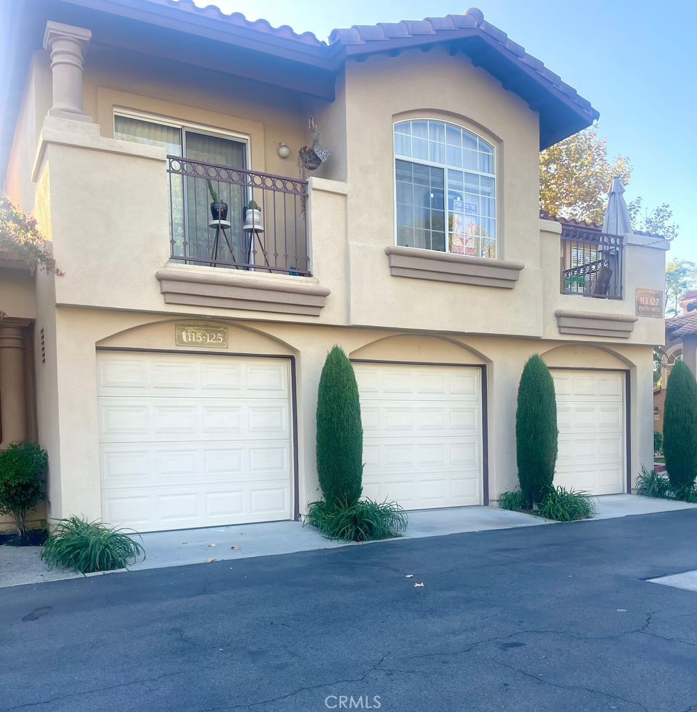 123 Pasto Rico Rancho Santa Margarita, CA 92688 - Photo 2 of 13 a front view of a house with a yard and garage