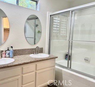 123 Pasto Rico Rancho Santa Margarita, CA 92688 - Photo 10 of 13 a bathroom with a granite countertop sink mirror and vanity