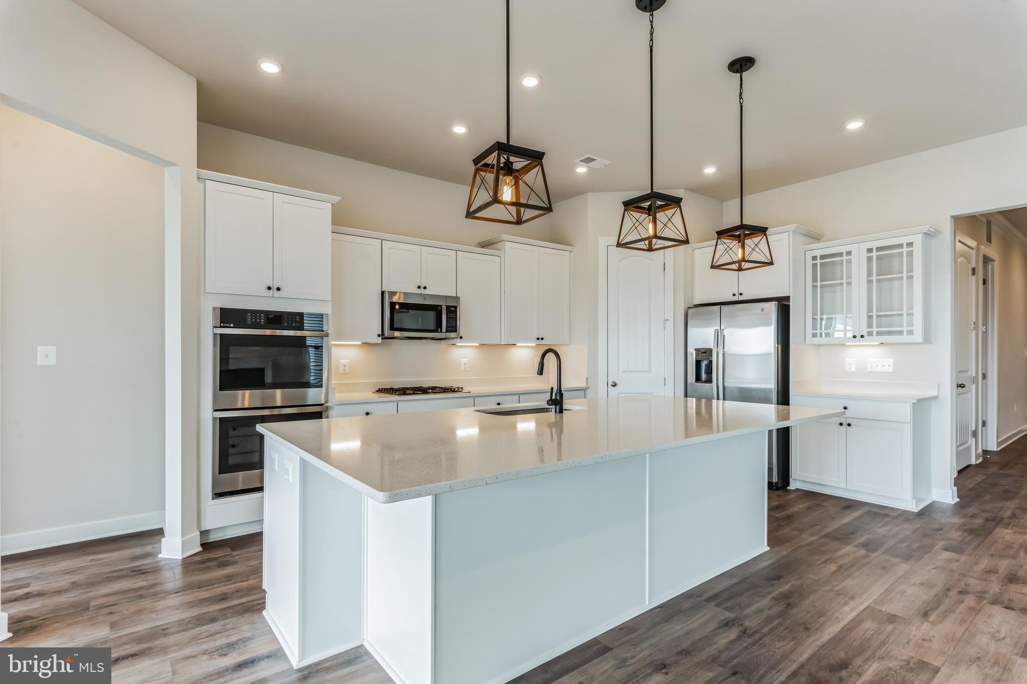21 Golden Raintree Court Middletown, DE 19709 - Photo 3 of 28 a kitchen with kitchen island white cabinets and stainless steel appliances
