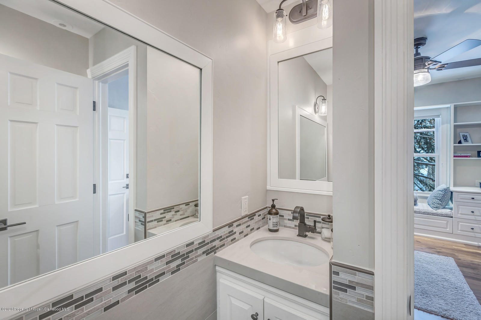 633 West Main Street Aspen, CO 81611 - Photo 19 of 46 a bathroom with a granite countertop sink and a mirror