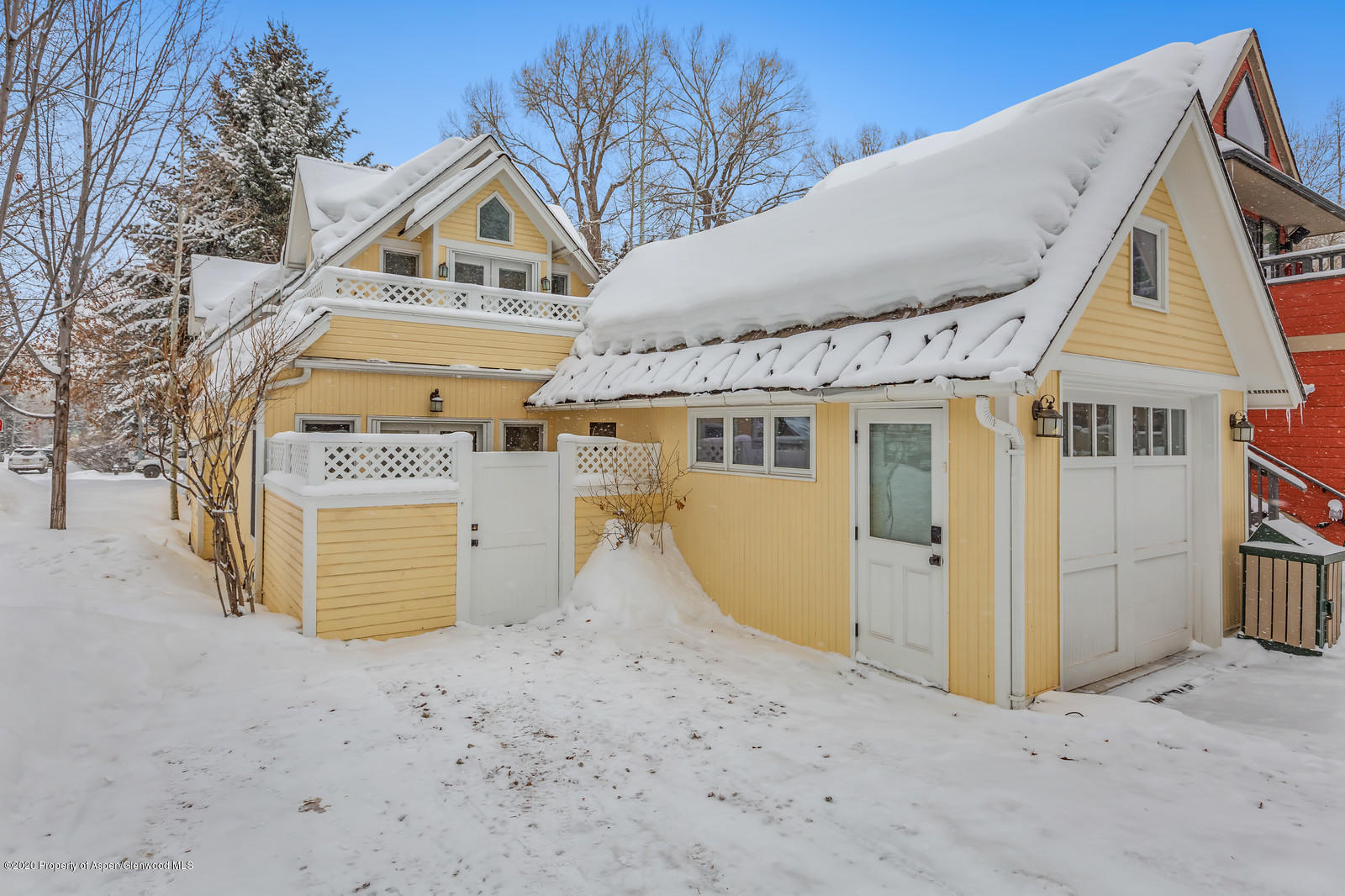 633 West Main Street Aspen, CO 81611 - Photo 24 of 46 a view of a house with a wooden fence