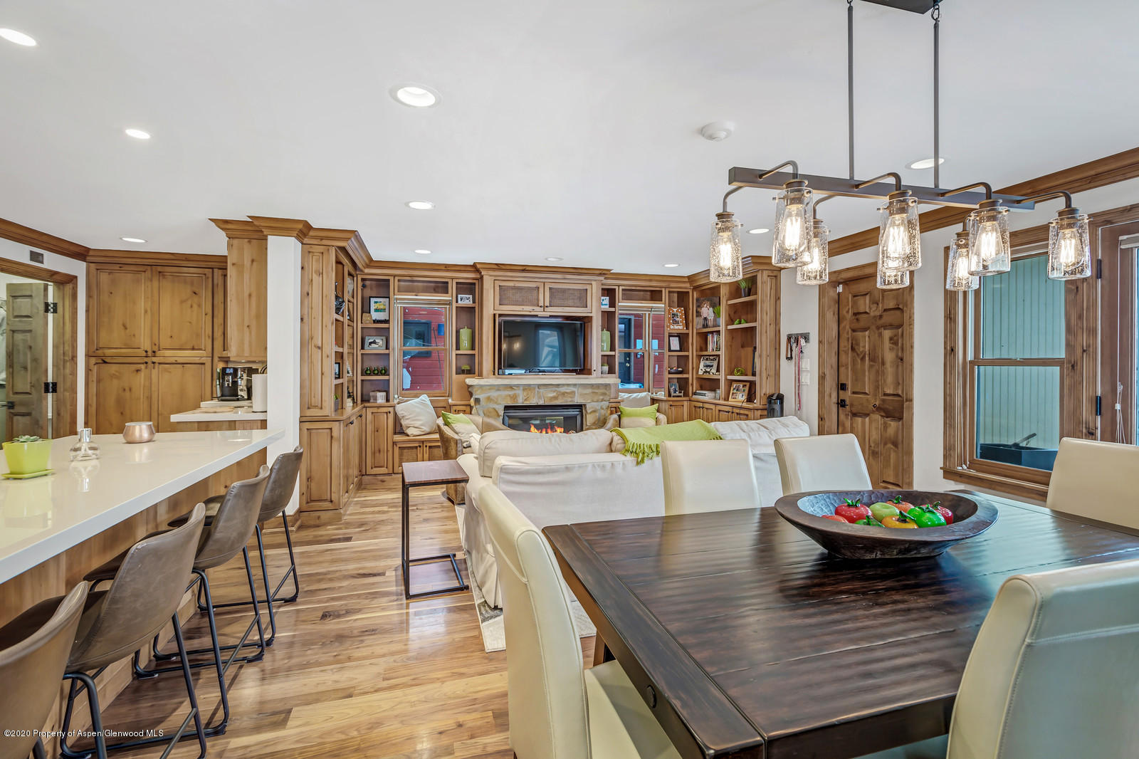 633 West Main Street Aspen, CO 81611 - Photo 35 of 46 a view of a dining room and livingroom with furniture wooden floor and a chandelier