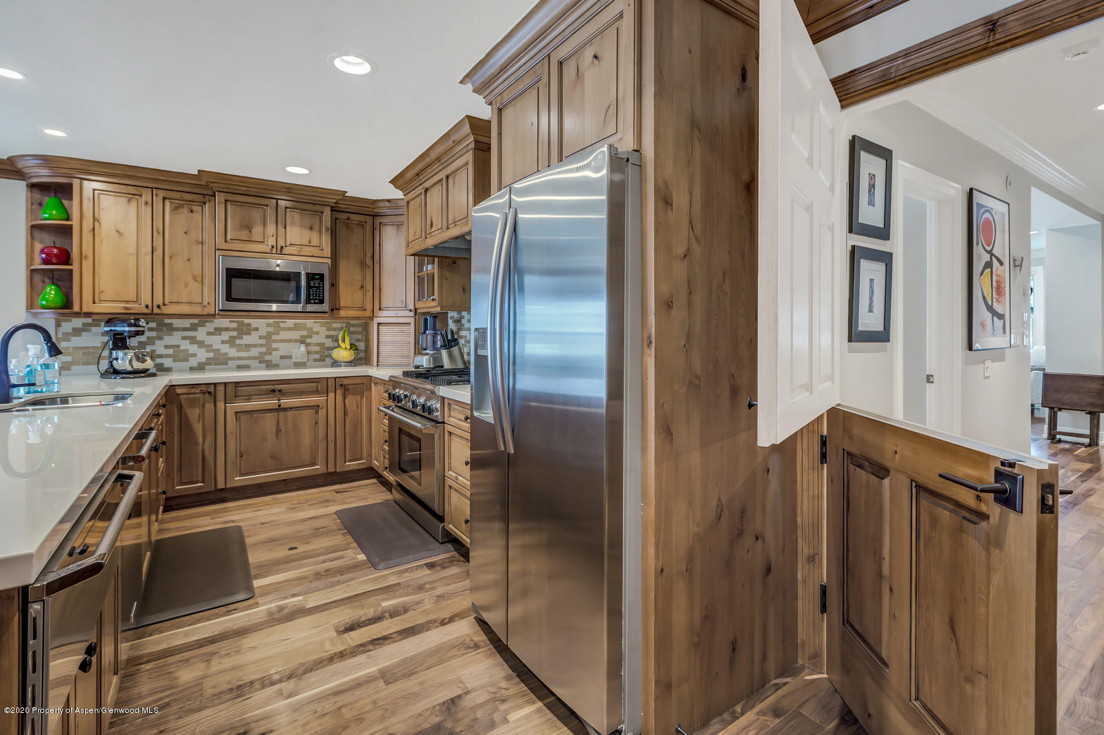 633 West Main Street Aspen, CO 81611 - Photo 41 of 46 a kitchen with stainless steel appliances granite countertop a refrigerator and a sink