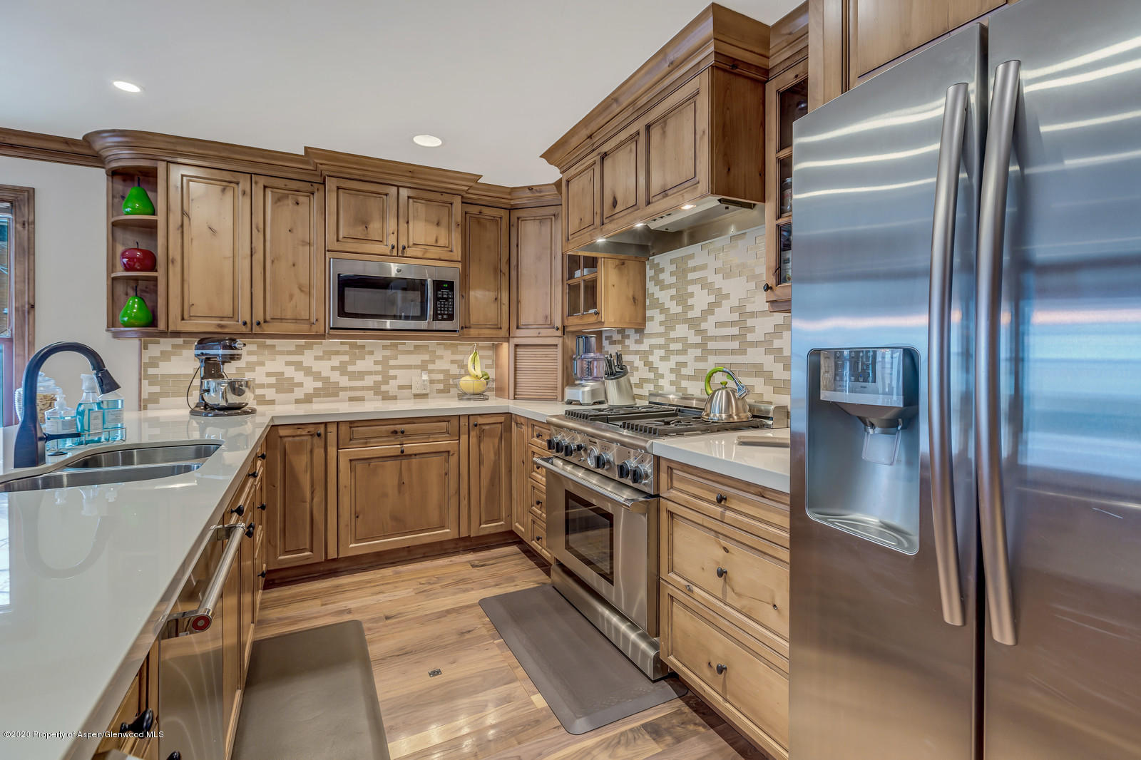 633 West Main Street Aspen, CO 81611 - Photo 42 of 46 a kitchen with stainless steel appliances granite countertop a refrigerator sink and stove