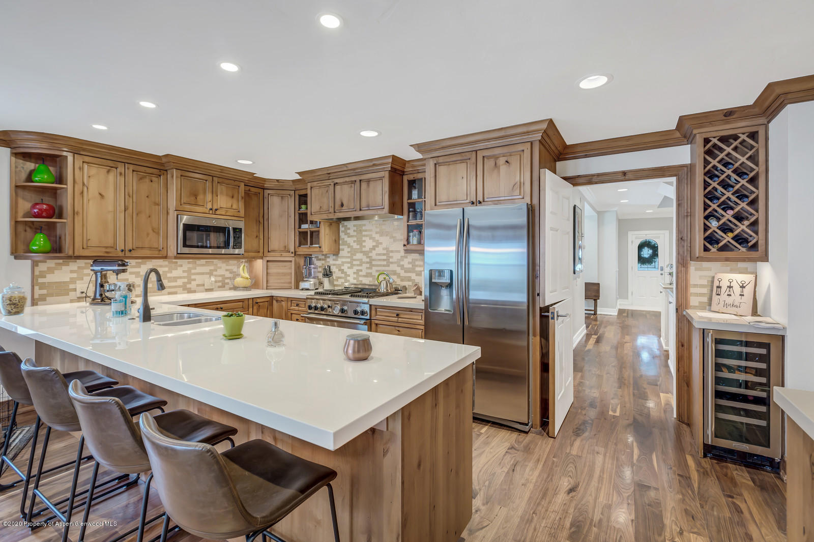 633 West Main Street Aspen, CO 81611 - Photo 46 of 46 a kitchen with stainless steel appliances granite countertop a refrigerator a stove and a sink with wooden floor