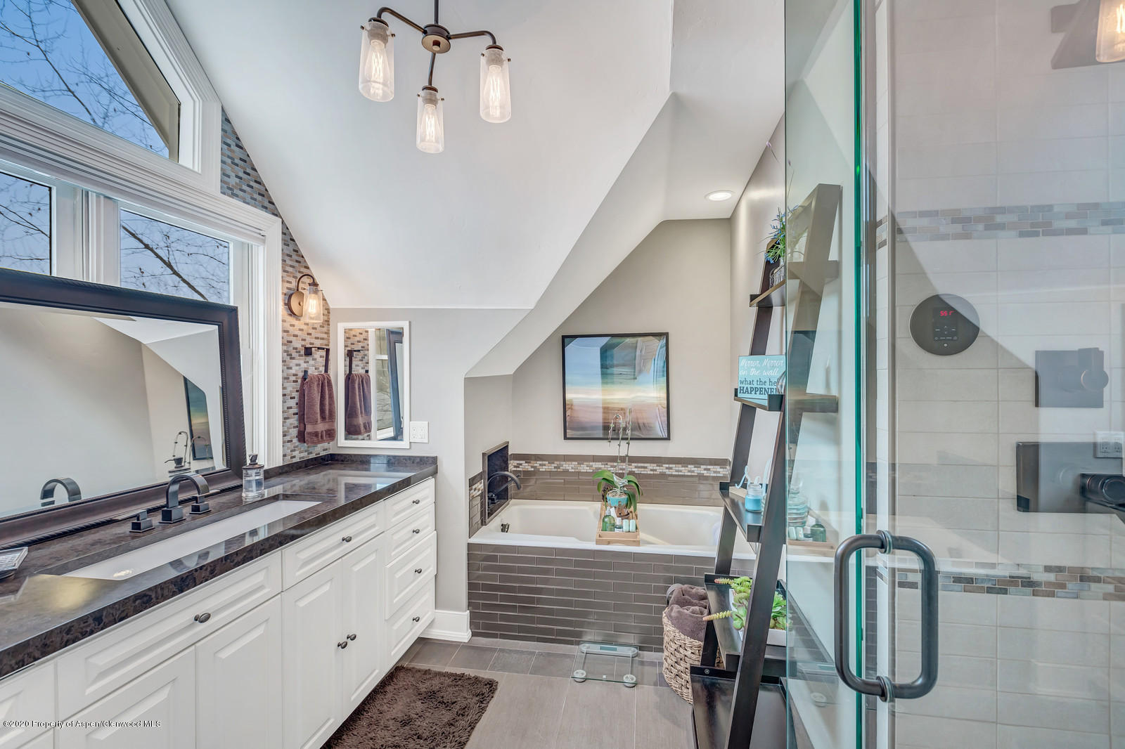 633 West Main Street Aspen, CO 81611 - Photo 9 of 46 a bathroom with double vanity and a mirror