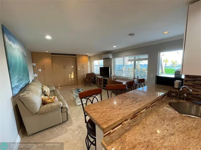 a living room with furniture rug and window