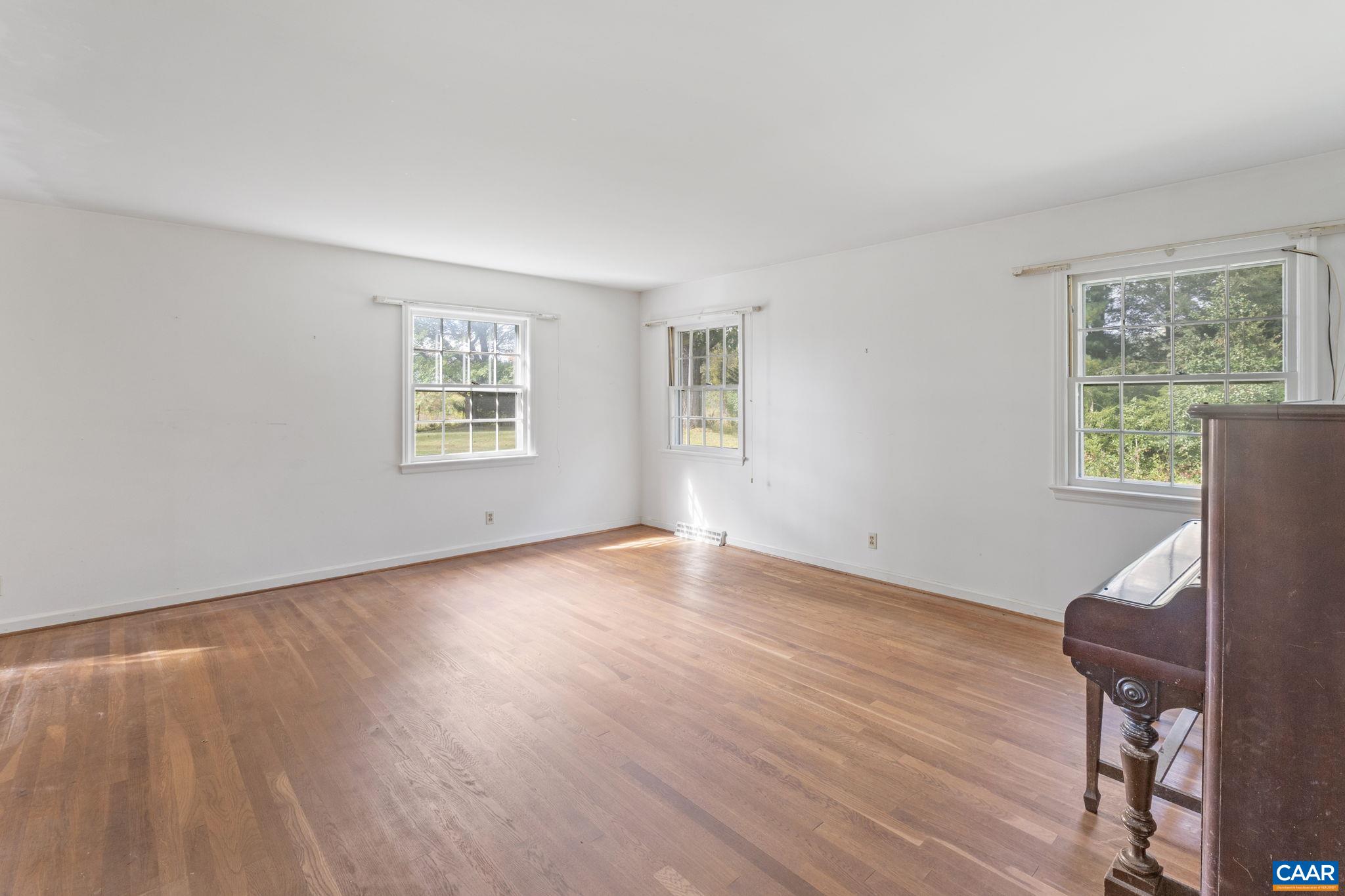 9281 Dick Woods Road Afton, VA 22920 - Photo 16 of 29 a view of an empty room with wooden floor and a window