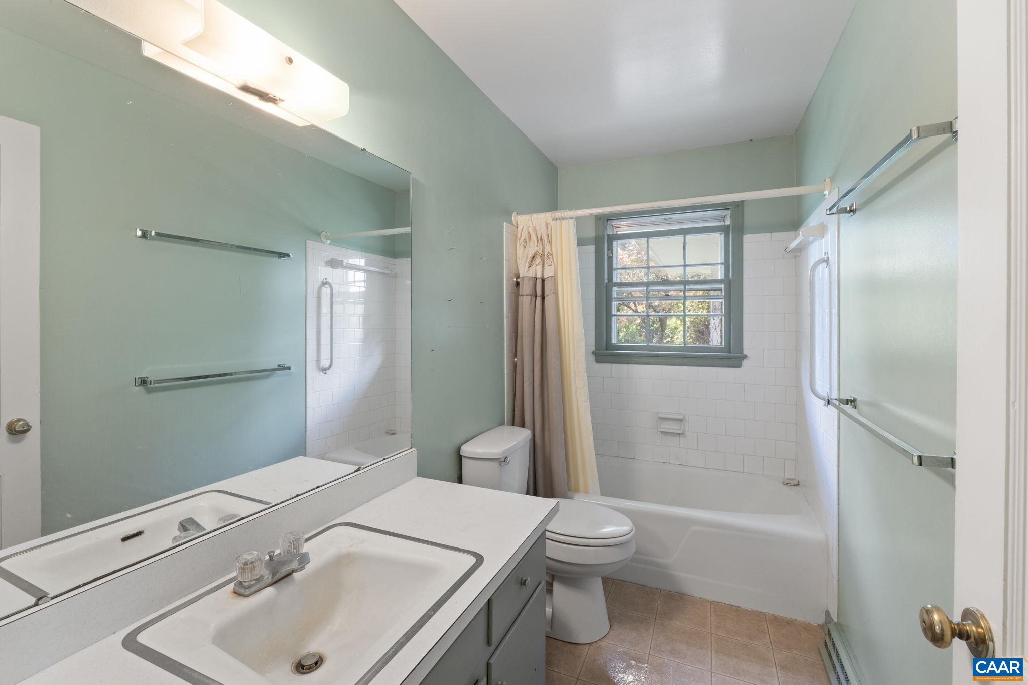 9281 Dick Woods Road Afton, VA 22920 - Photo 19 of 29 a bathroom with a sink toilet and shower