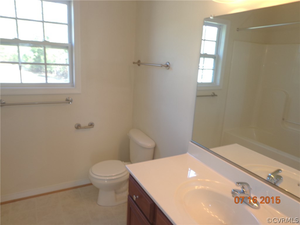 5700 Garden Ridge Road Chesterfield, VA 23832 - Photo 14 of 18 a bathroom with a toilet a sink and a window