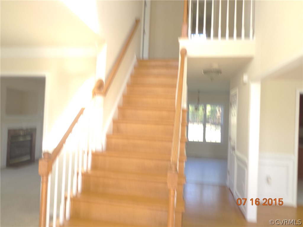5700 Garden Ridge Road Chesterfield, VA 23832 - Photo 3 of 18 a view of a hallway with wooden floor and staircase