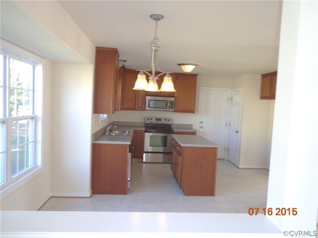 5700 Garden Ridge Road Chesterfield, VA 23832 - Photo 5 of 18 a room with kitchen island stainless steel appliances a stove a sink and a window