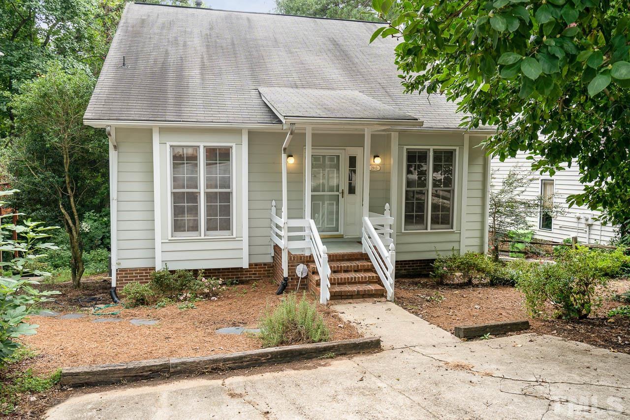 2913 Rue Sans Famille Raleigh, NC 27607 - Photo 2 of 25 a front view of a house with garden