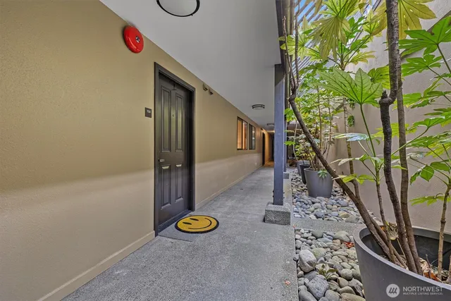 a living room with furniture a fireplace and a large window