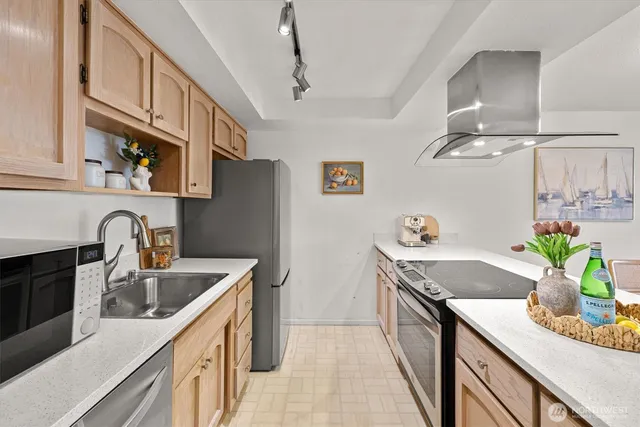 a view of a dining room with furniture a chandelier and wooden floor