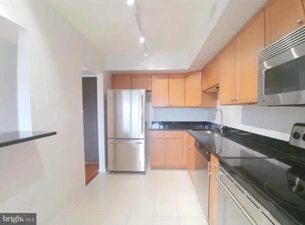 a kitchen with a refrigerator and a sink