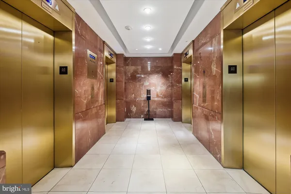 a bathroom with a glass shower door mirror and shower