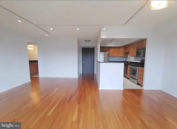 a view of a kitchen with wooden floor and a kitchen