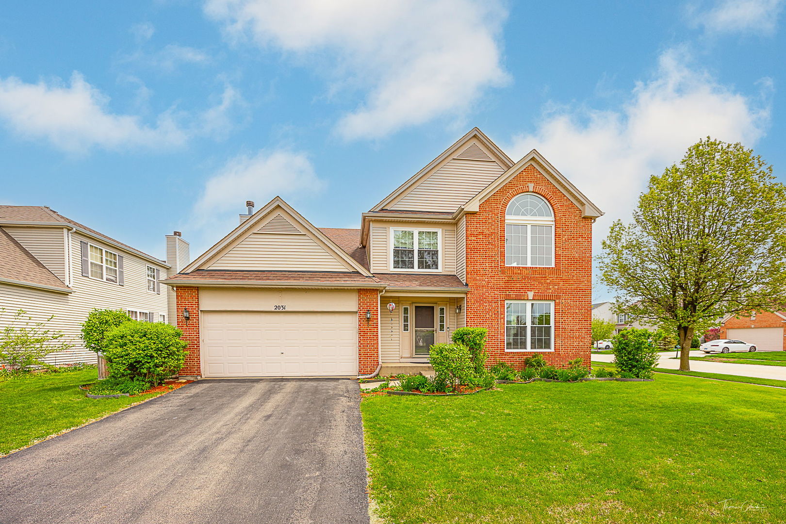 2031 Crosswind Drive Plainfield, IL 60586 - Photo 2 of 35 a front view of a house with a yard and garage