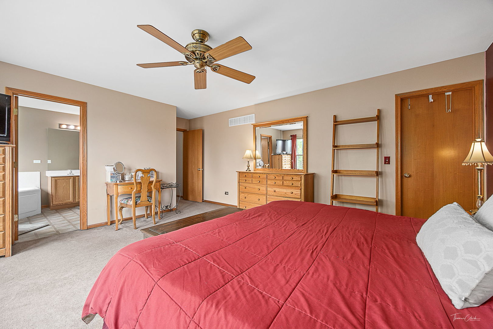 2031 Crosswind Drive Plainfield, IL 60586 - Photo 27 of 35 a bedroom with a large bed and a chandelier