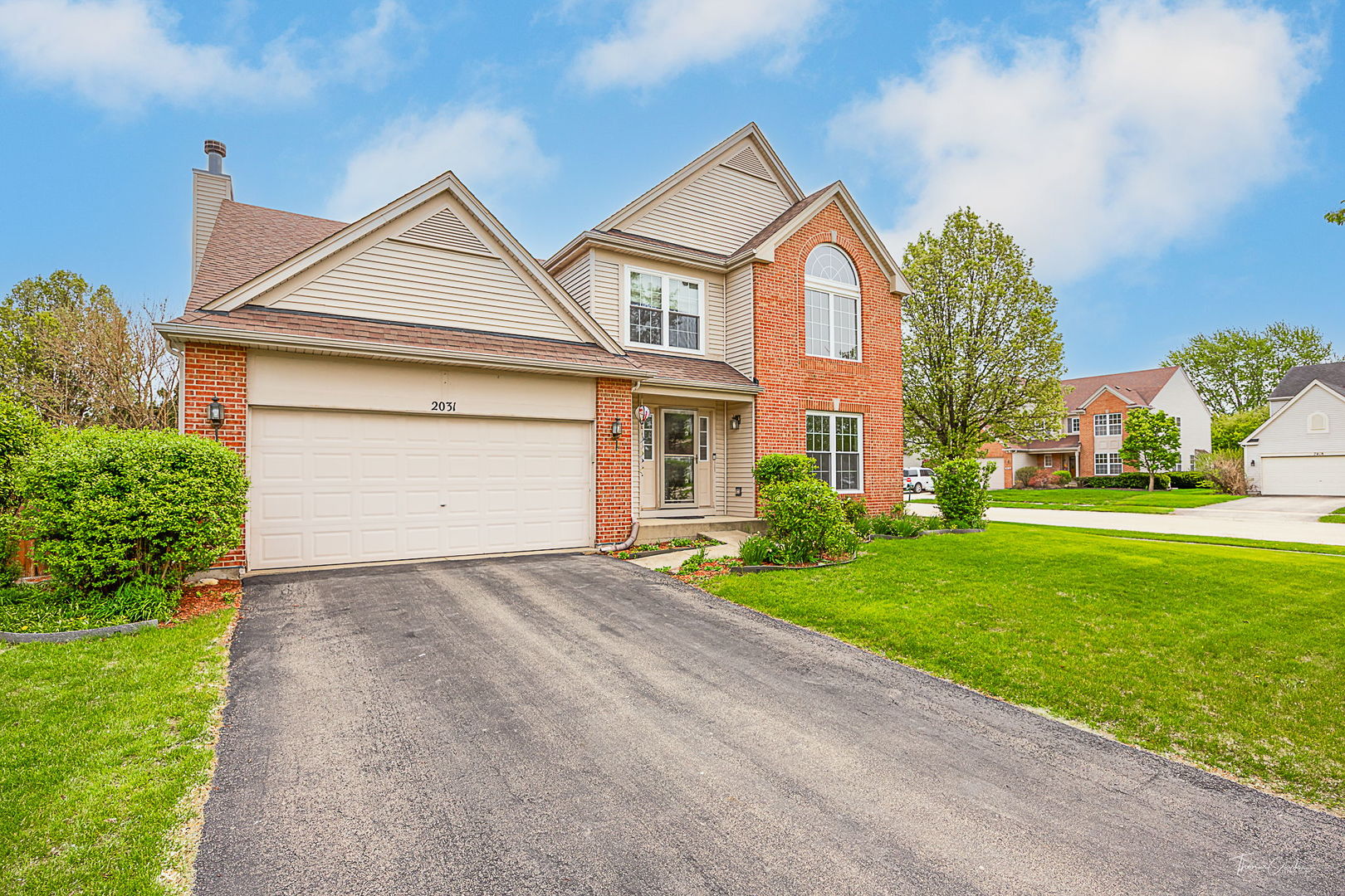 2031 Crosswind Drive Plainfield, IL 60586 - Photo 3 of 35 a front view of a house with a yard and garage