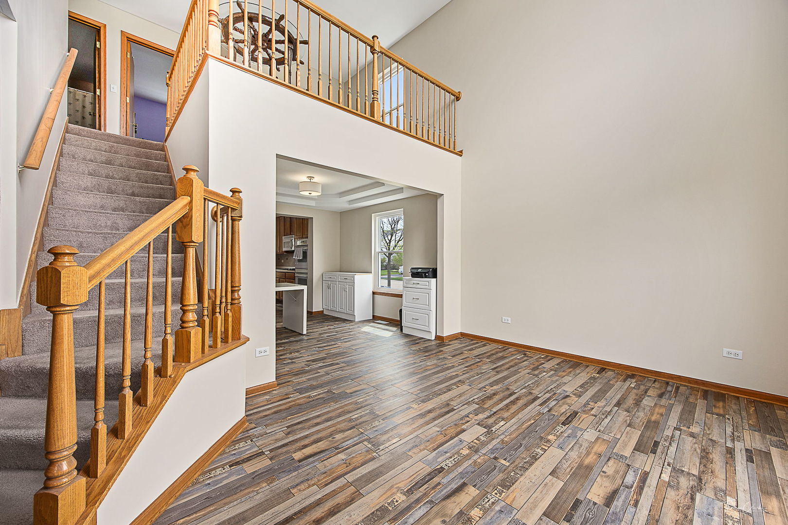2031 Crosswind Drive Plainfield, IL 60586 - Photo 7 of 35 a view of a hallway with wooden floor and staircase