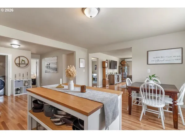 a kitchen with stainless steel appliances kitchen island a table and chairs in it