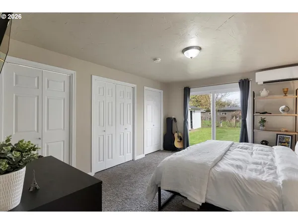 a bedroom with a bed and a potted plant