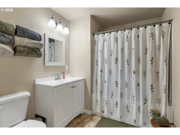 a bathroom with a toilet a sink and a mirror