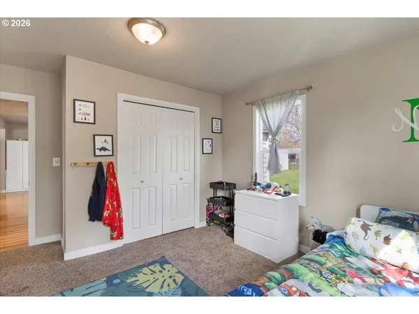a view of room with baby crib and toys
