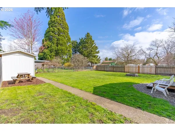 a view of yard with swimming pool and green space