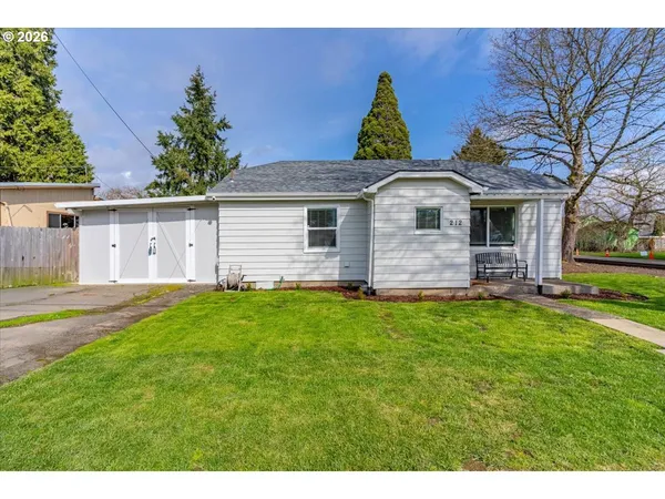 a front view of house with yard and outdoor seating