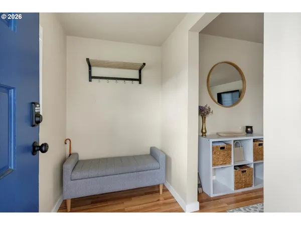 a view of living room with furniture and mirror