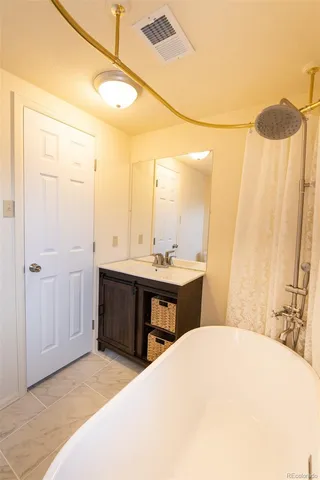 a spacious bathroom with a double vanity sink and a mirror