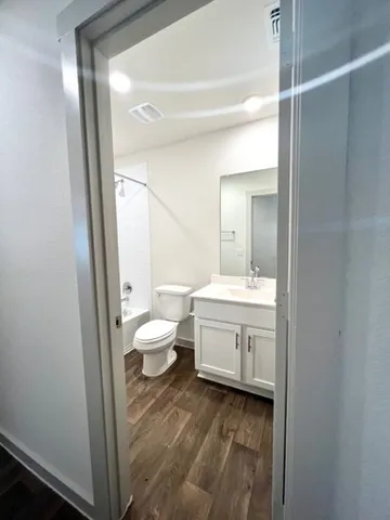 a bathroom with a sink a toilet and a mirror