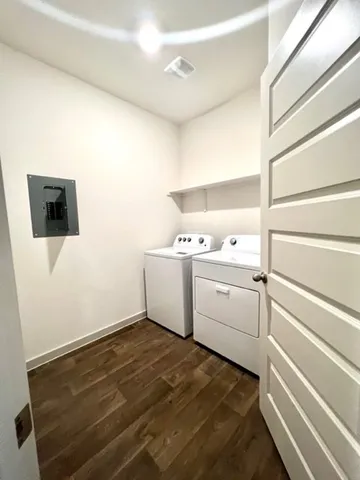 a utility room with cabinets washer and dryer