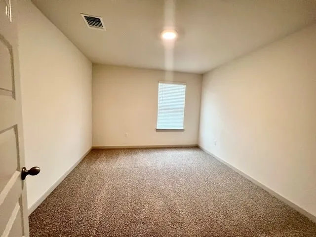 an empty room with a empty space and windows