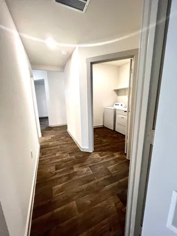 a view of a hallway view with wooden floor and staircase