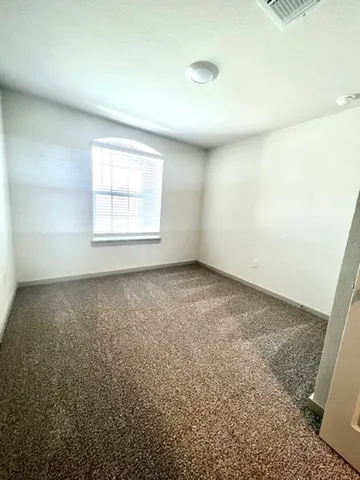 an empty room with a empty space and windows