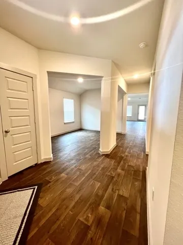 a view of a hallway with wooden floor
