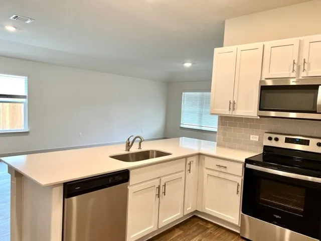 a kitchen that has a sink and a stove